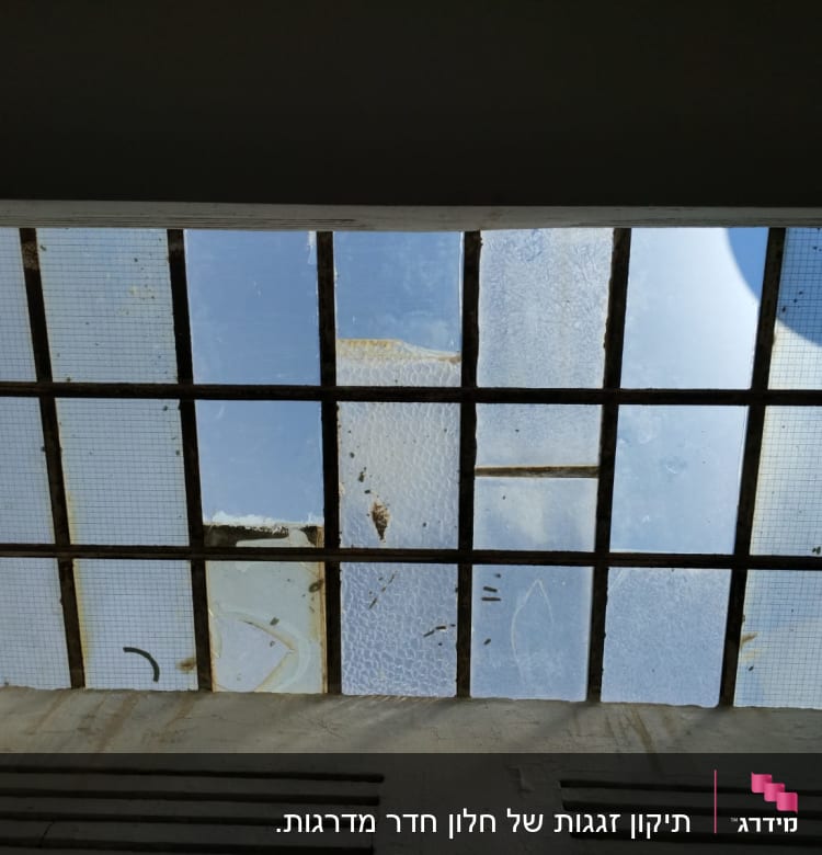 חלון זכוכית עם סורגים ומסגרת מתכת